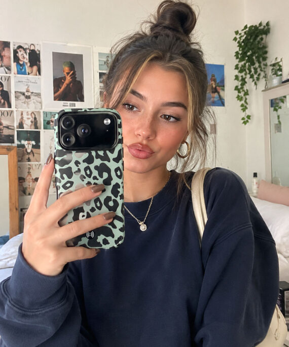 Mint green leopard print phone case shown in a lifestyle mirror selfie
