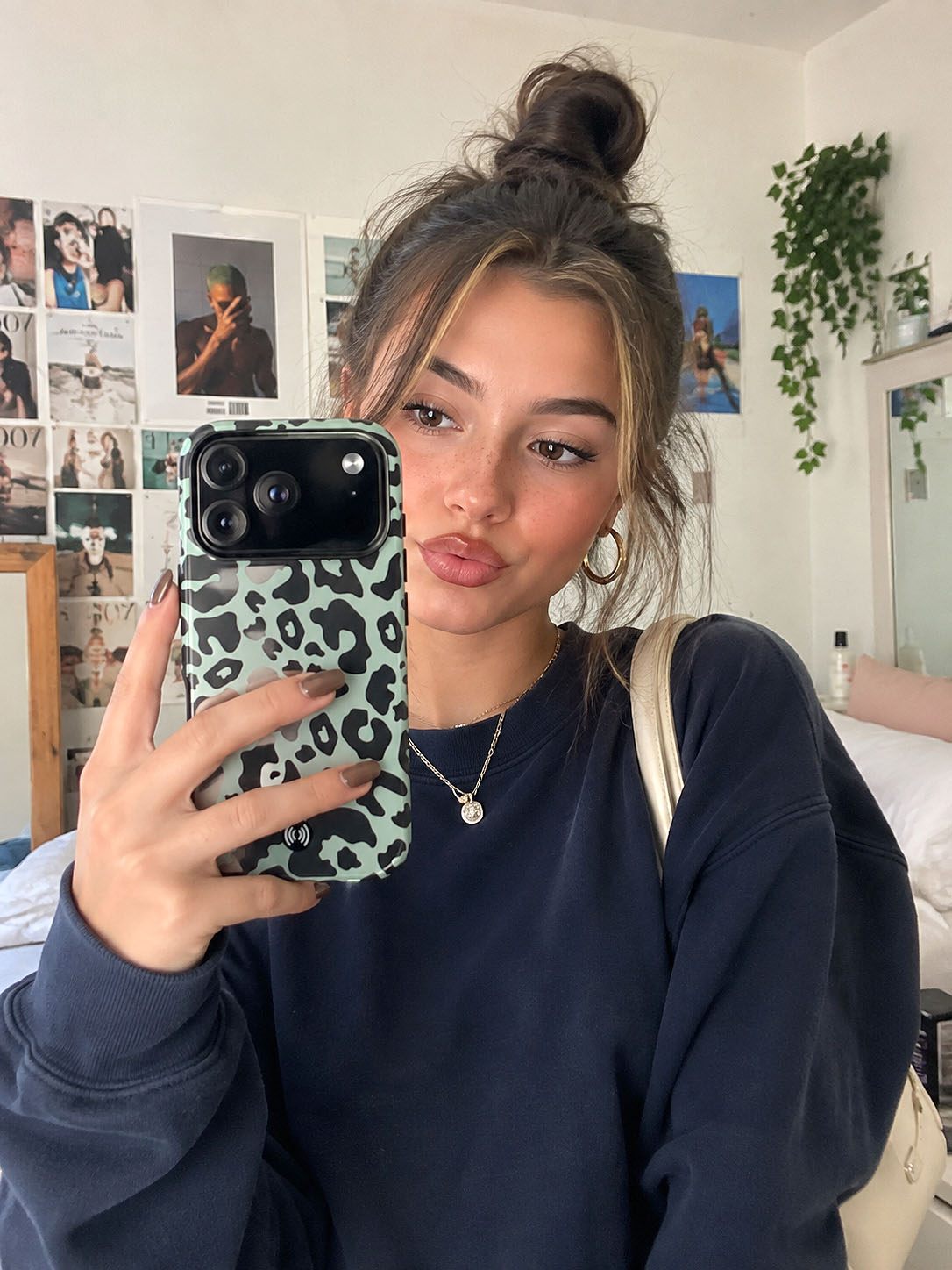 Mint green leopard print phone case shown in a lifestyle mirror selfie